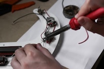 A person is working on some electrical equipment