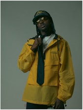 A man in a yellow jacket and tie