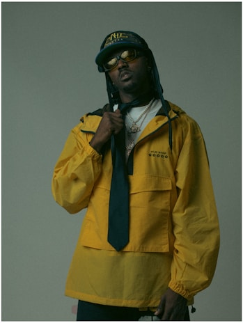 A man in a yellow jacket and tie