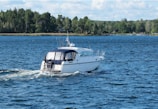 A white boat traveling across a large body of water