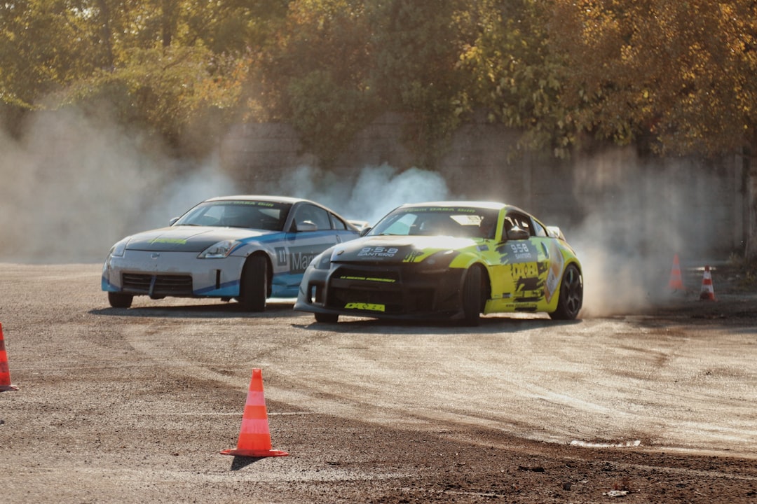 A couple of cars that are sitting in the dirt,