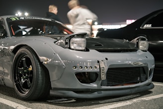 A silver race car parked in a parking lot