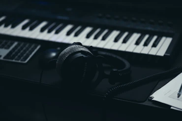 A keyboard with headphones and a microphone