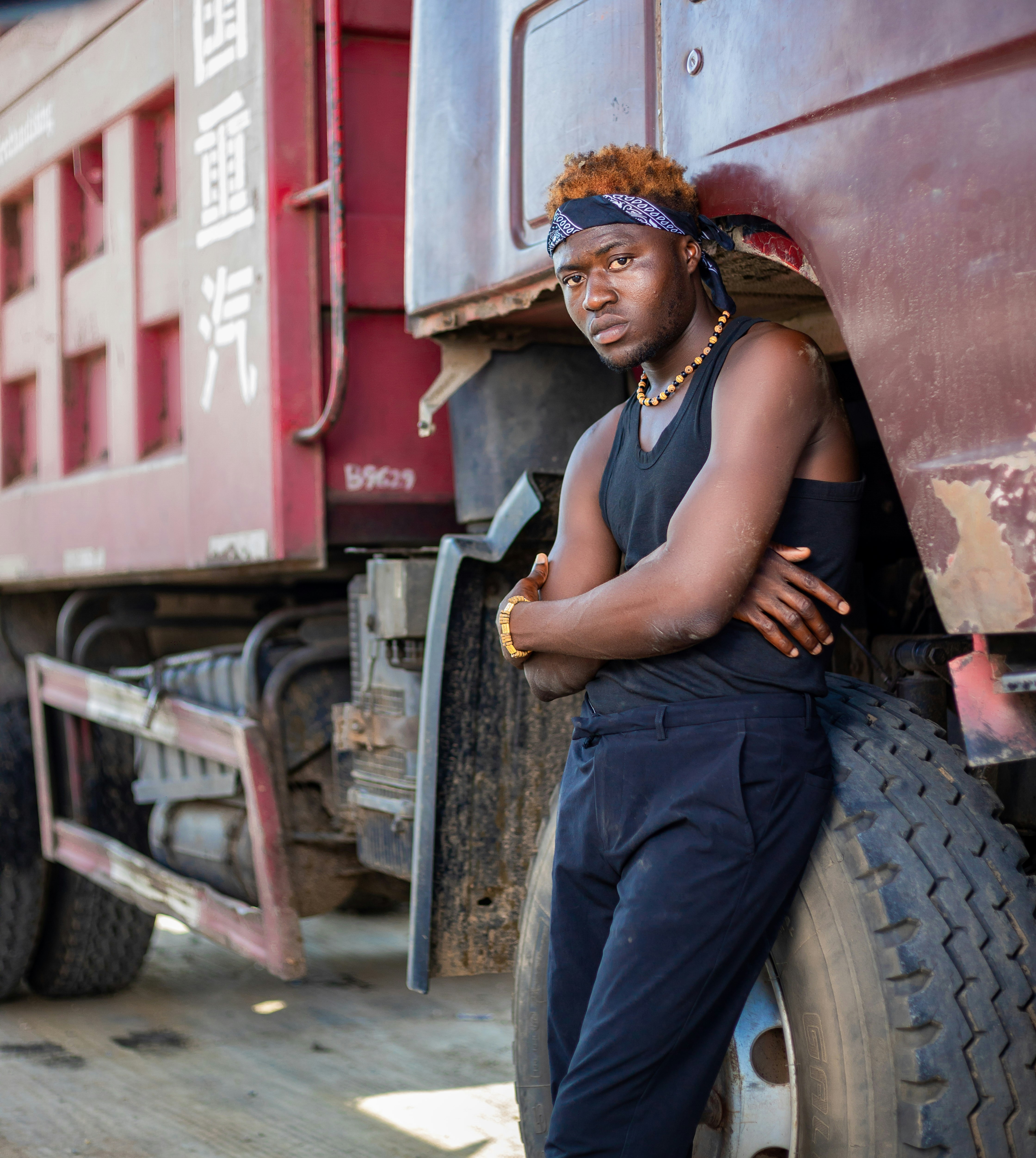 A man leaning against the side of a semi truck