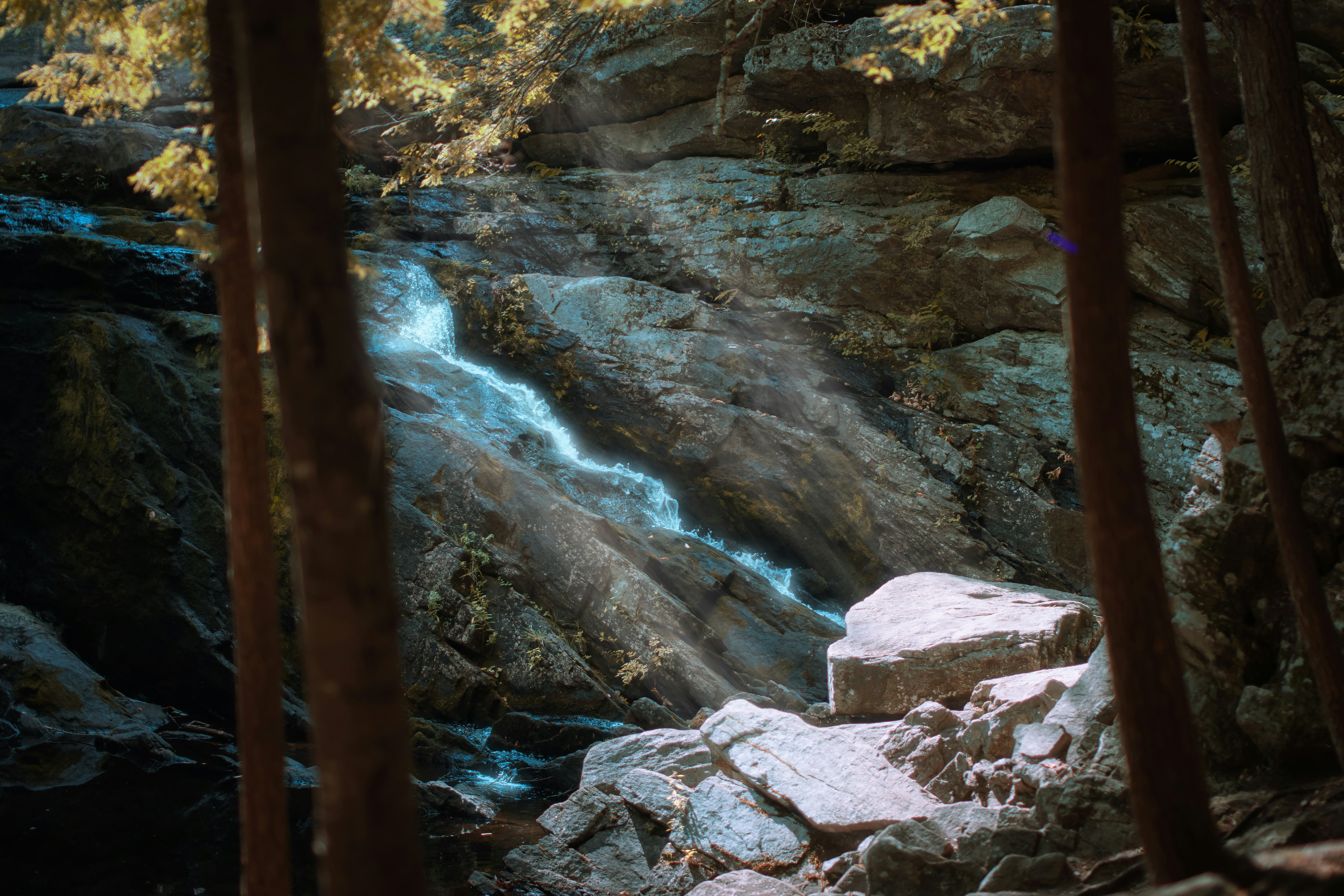 A waterfall in the middle of a wooded area