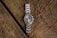 A watch sitting on top of a wooden table