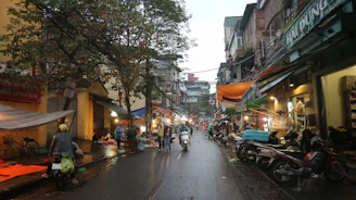A group of people riding motorcycles down a street