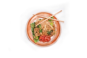 A plate of food with chopsticks on it
