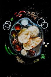 A plate of food on a black table