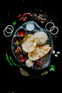 A plate of food on a black table
