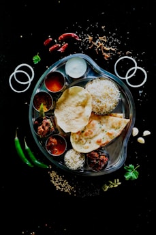 A plate of food on a black table