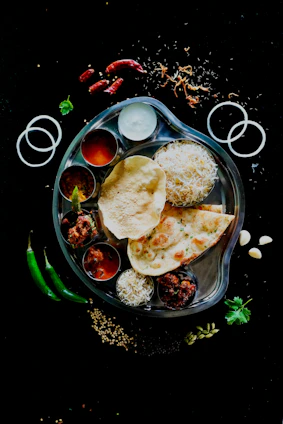 A plate of food on a black table