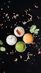 A group of small bowls filled with different types of food
