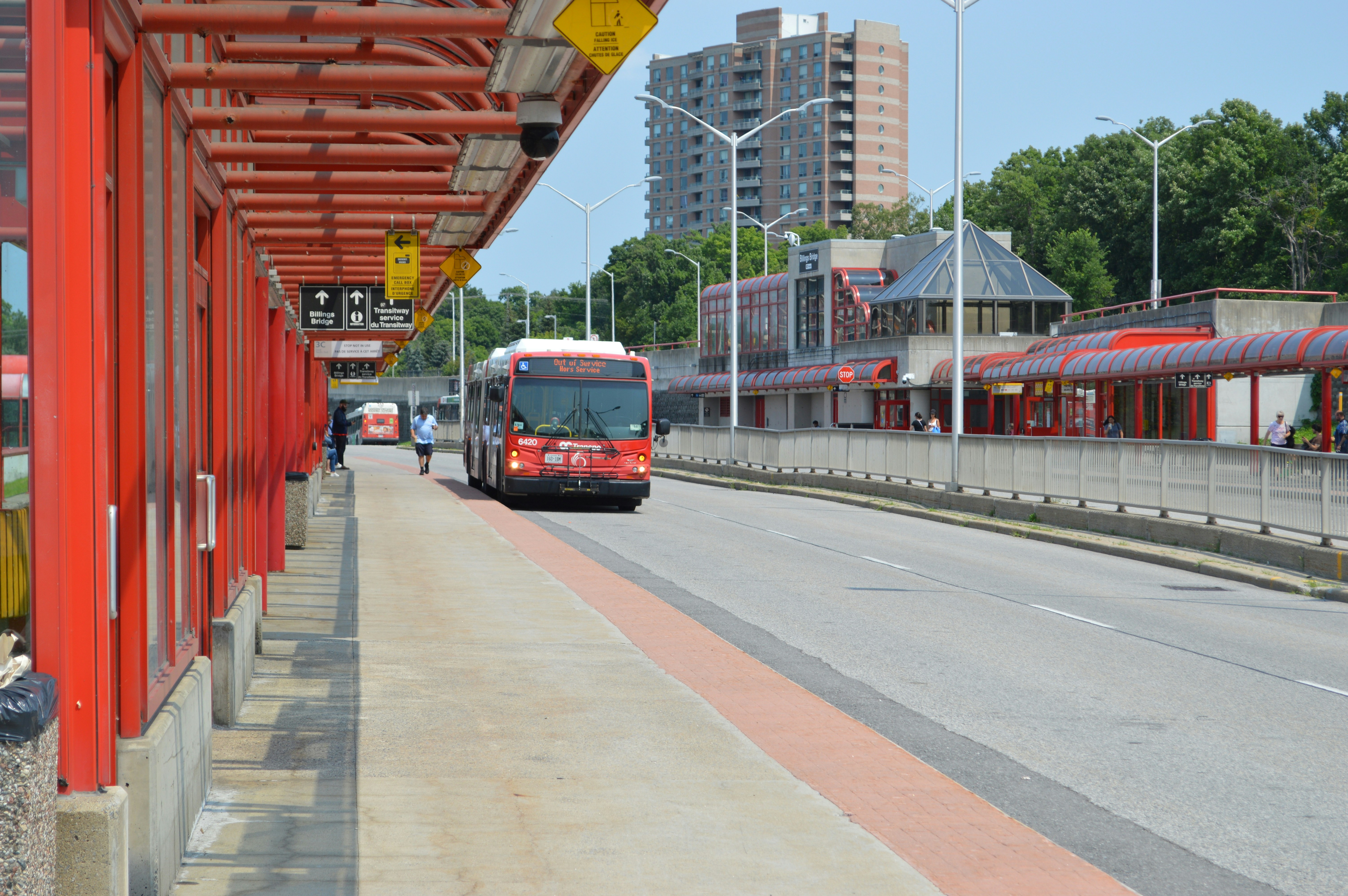 vibrant walkable neighborhood with mixed-use buildings near a transit station - Apartments near public transport