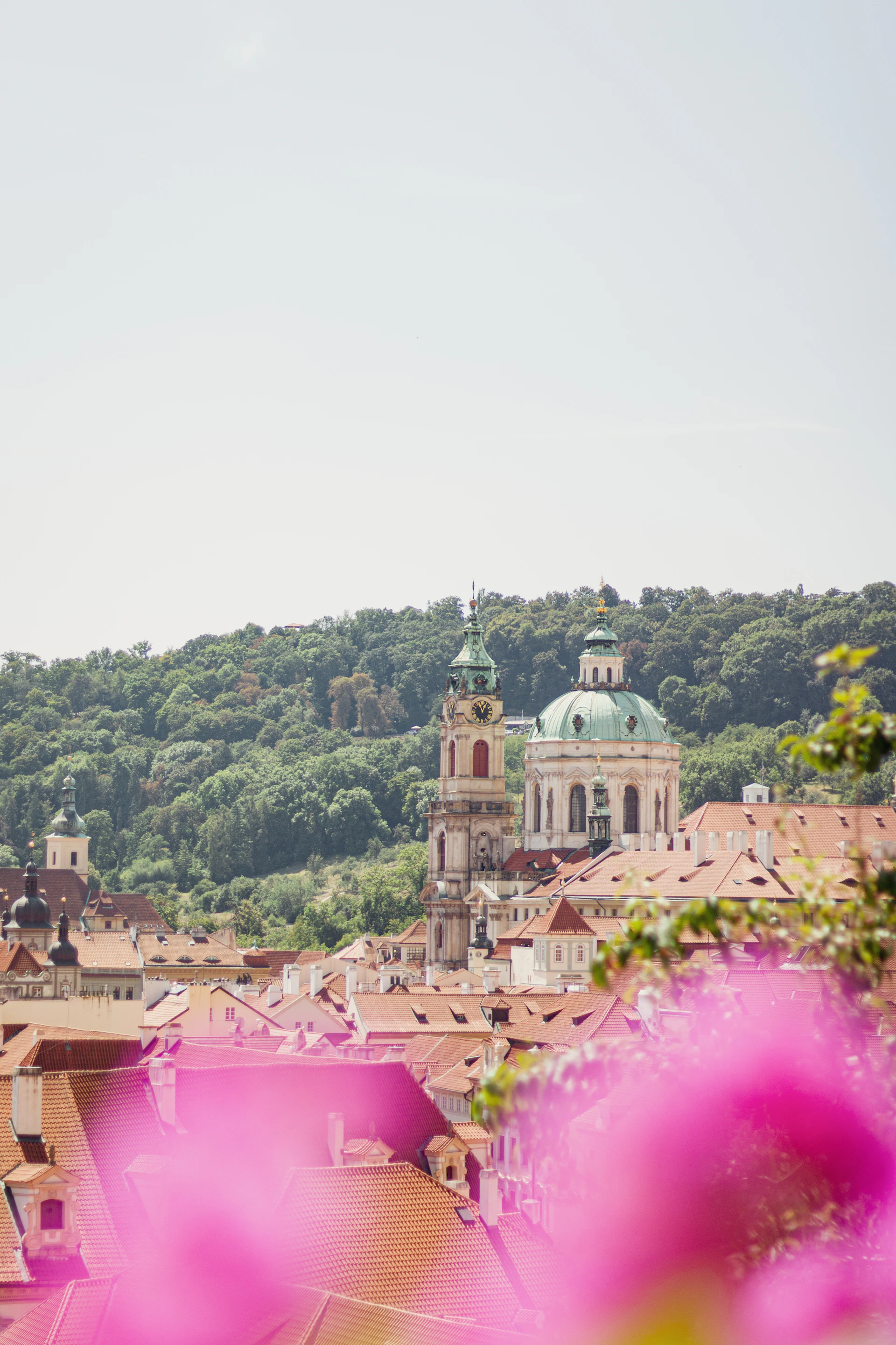 A view of a city with a clock tower in the background