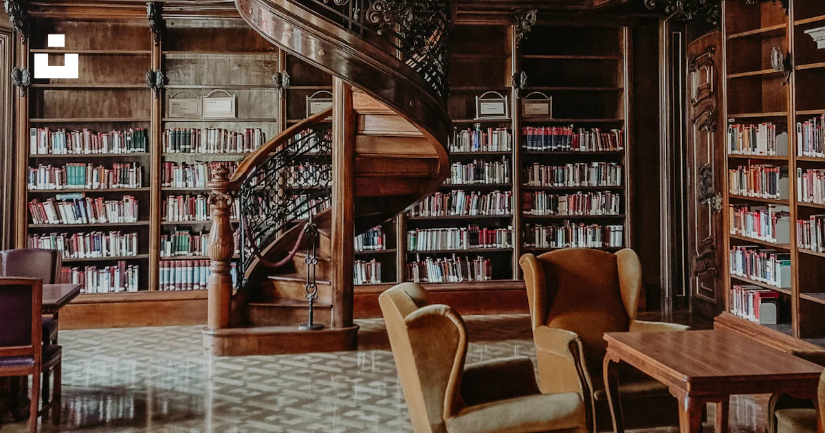 A library with a chandelier, couches, and tables photo – Free ...