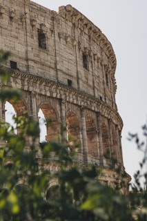 A close up of a very old building with trees in front of it