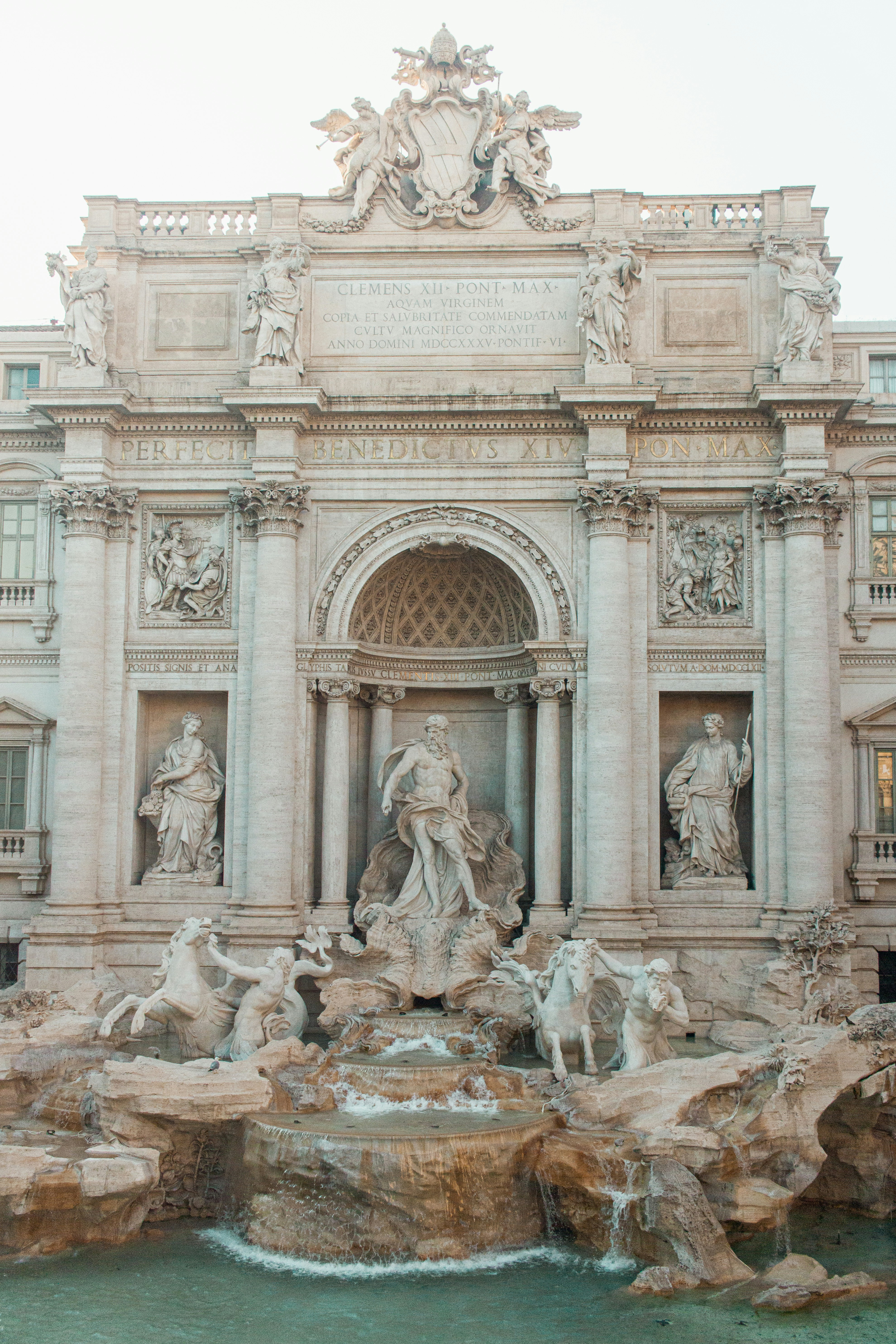 A large building with a fountain in front of it
