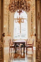 A dining room with a chandelier and a table