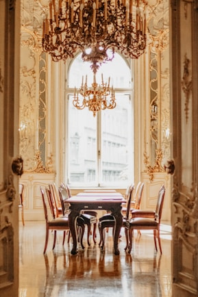 A dining room with a chandelier and a table