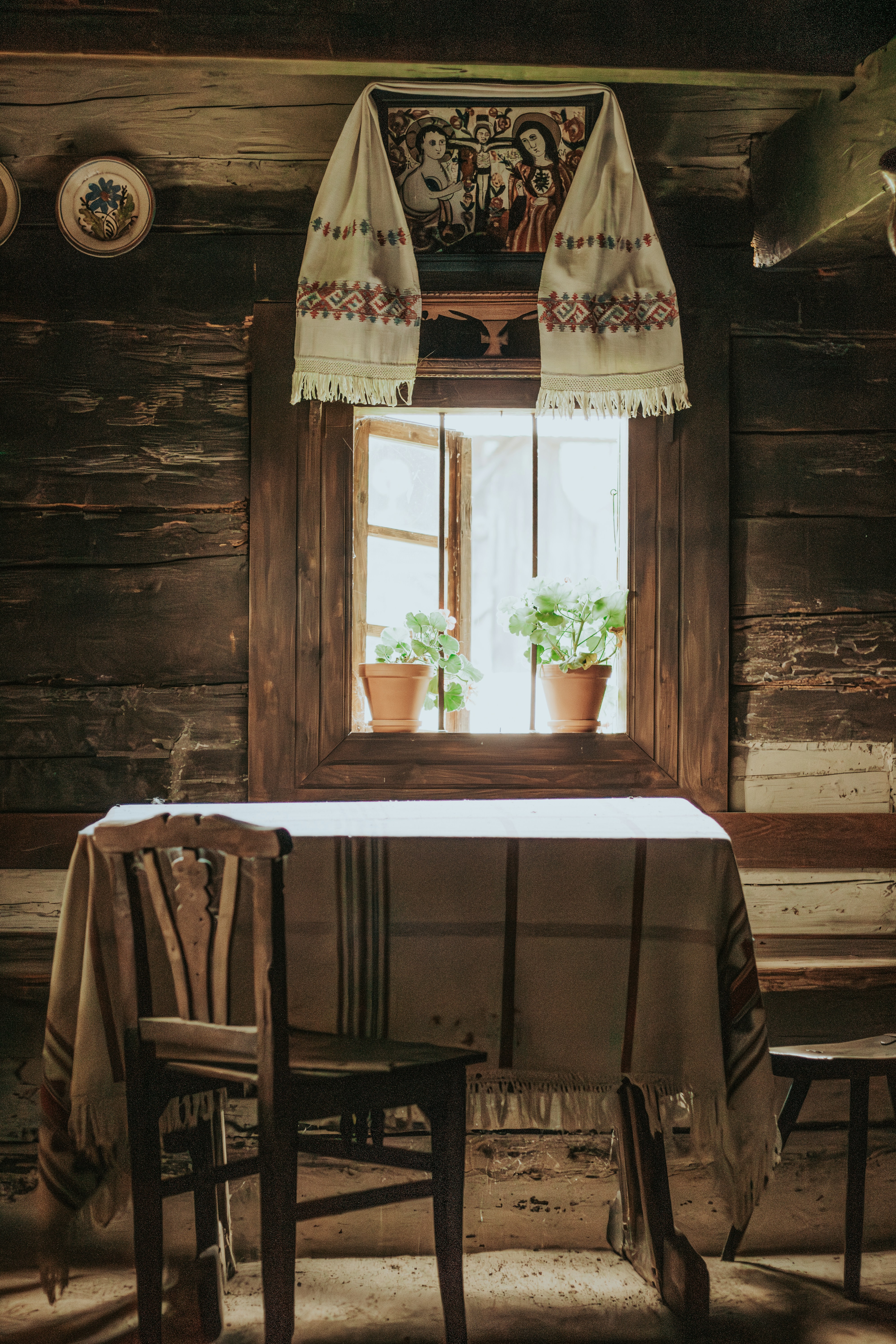 A table and chairs in front of a window