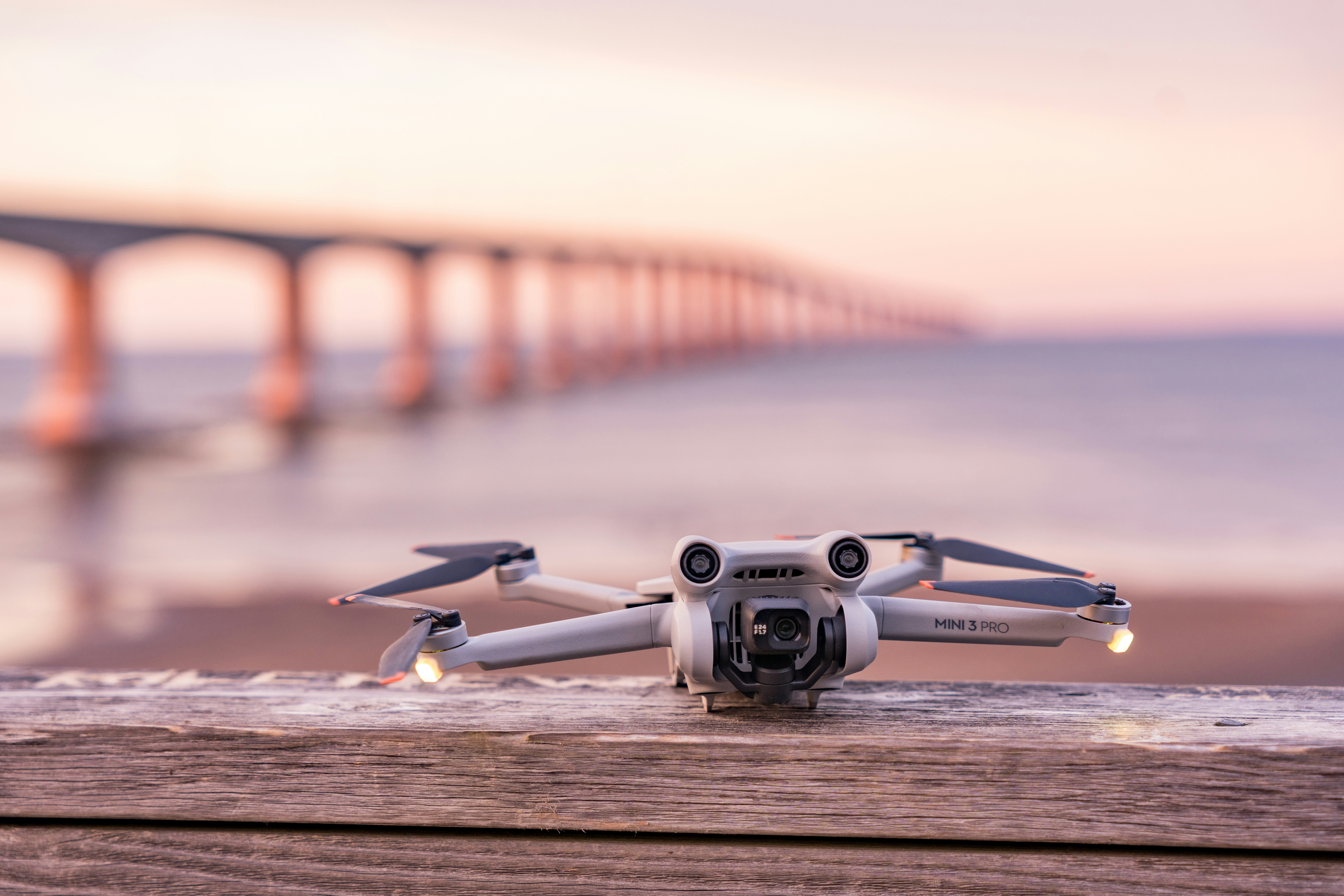 A small white camera sitting on top of a wooden table