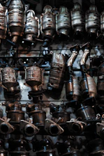 A bunch of metal pots and pans hanging on a wall