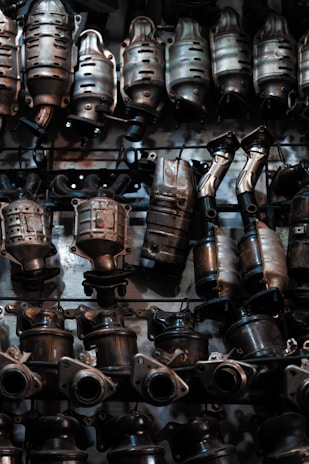 A bunch of metal pots and pans hanging on a wall