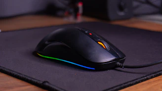 A computer mouse sitting on top of a mouse pad