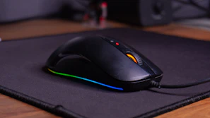 A computer mouse sitting on top of a mouse pad
