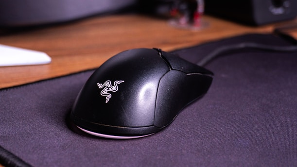 A computer mouse sitting on top of a mouse pad