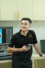 A man standing in front of a computer desk