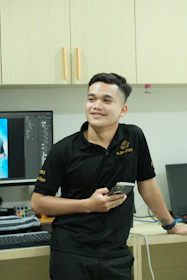 A man standing in front of a computer desk
