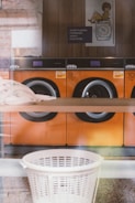 A row of washing machines in a store window