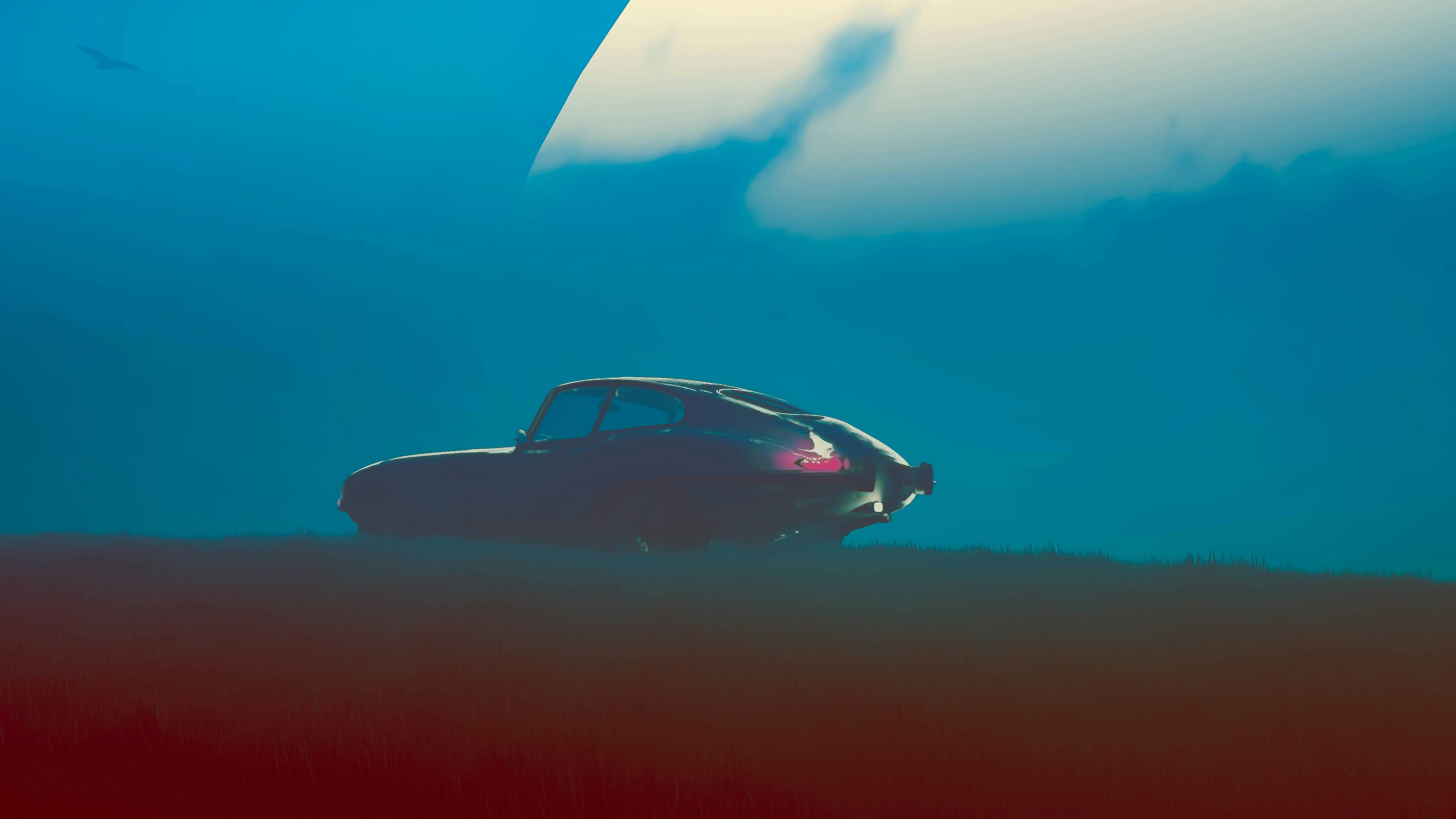 A car is sitting in the middle of a field