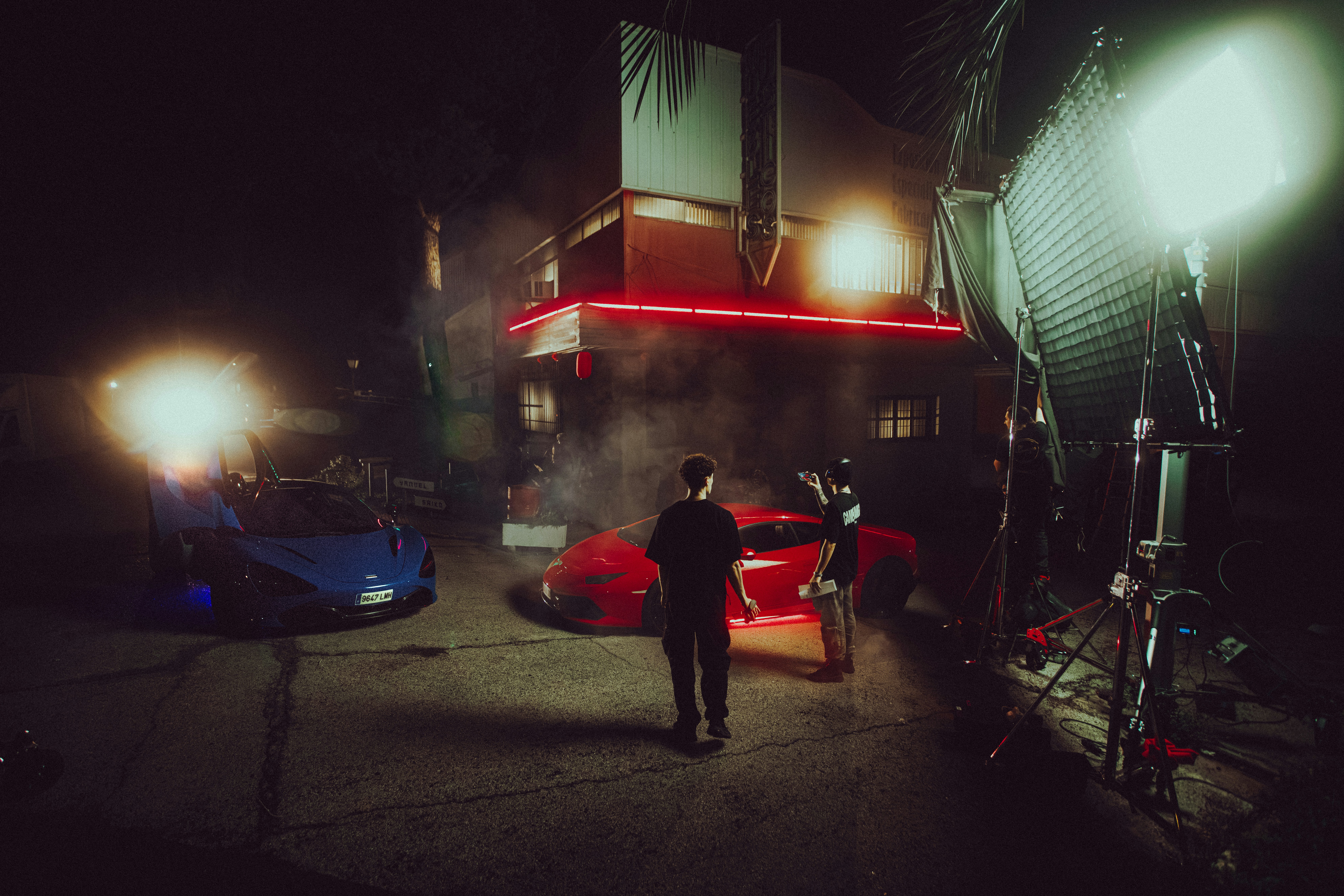 A man standing in the middle of a street at night