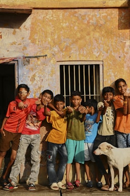 A group of children standing in front of a building
