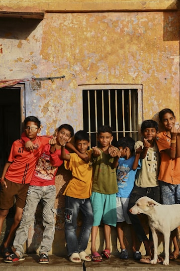 A group of children standing in front of a building