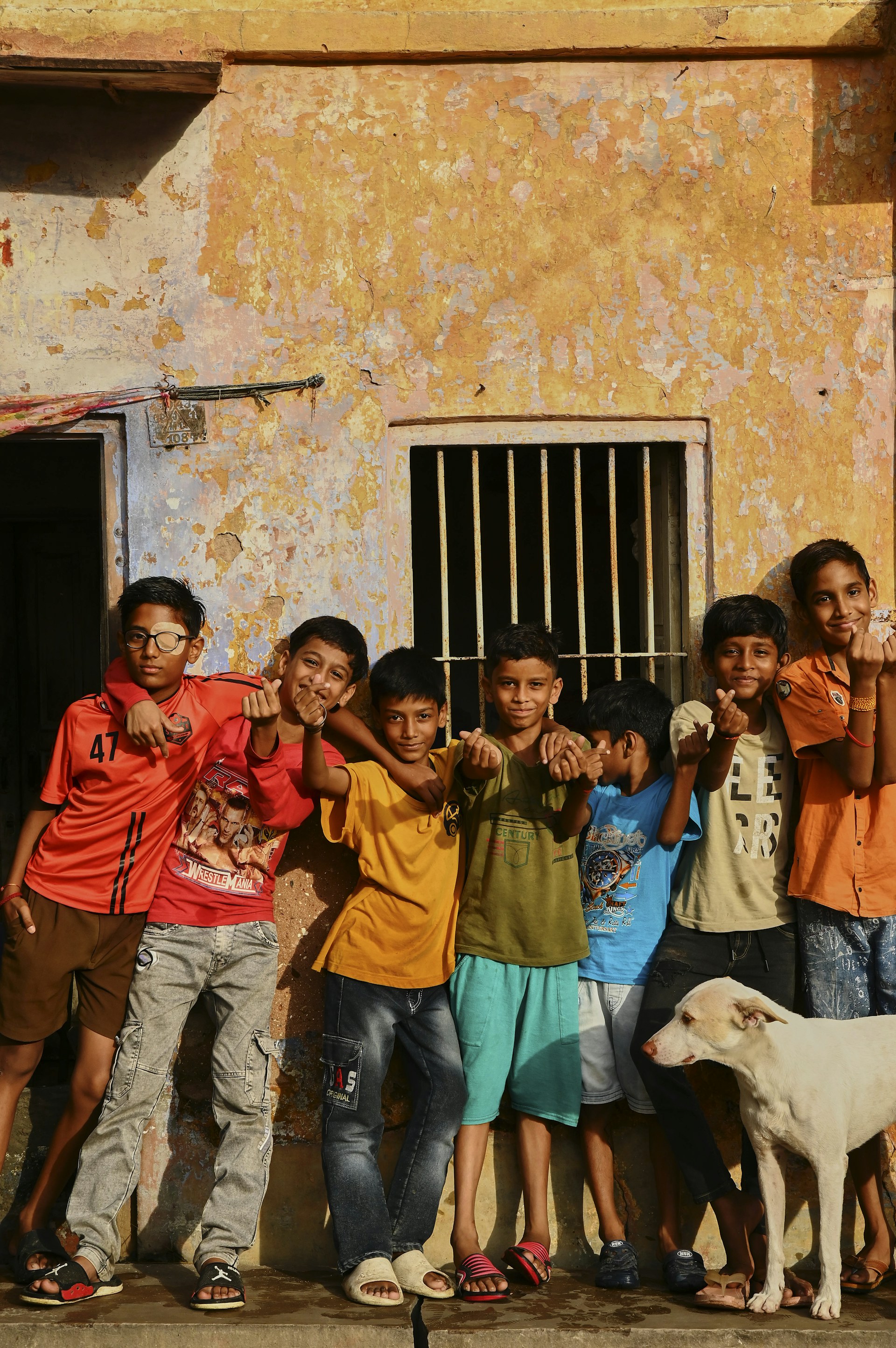 A group of children standing in front of a building