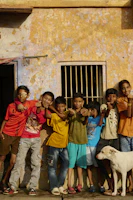 A group of children standing in front of a building
