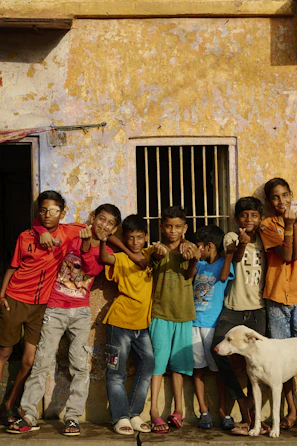 A group of children standing in front of a building