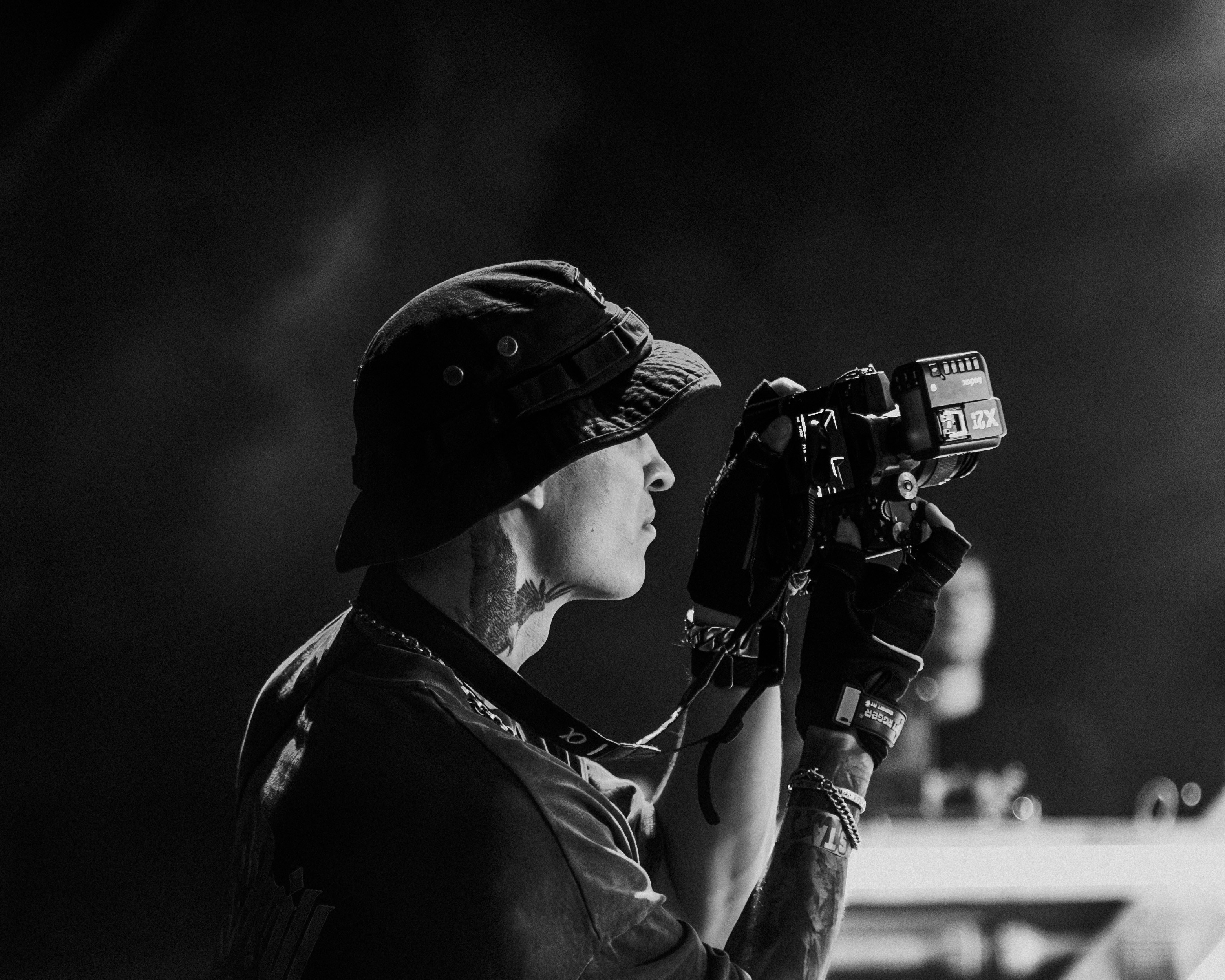 A black and white photo of a man holding a camera