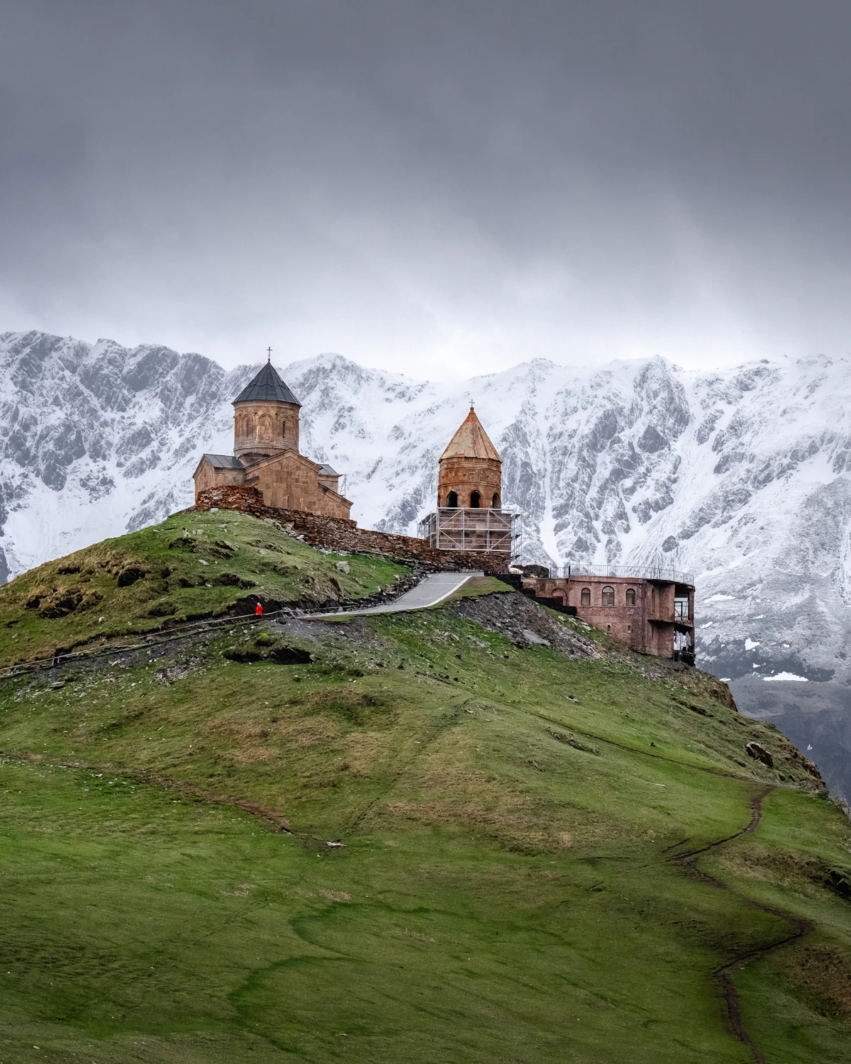 Gergeti Trinity Church beneath the snowy Caucasus mountains in Georgia