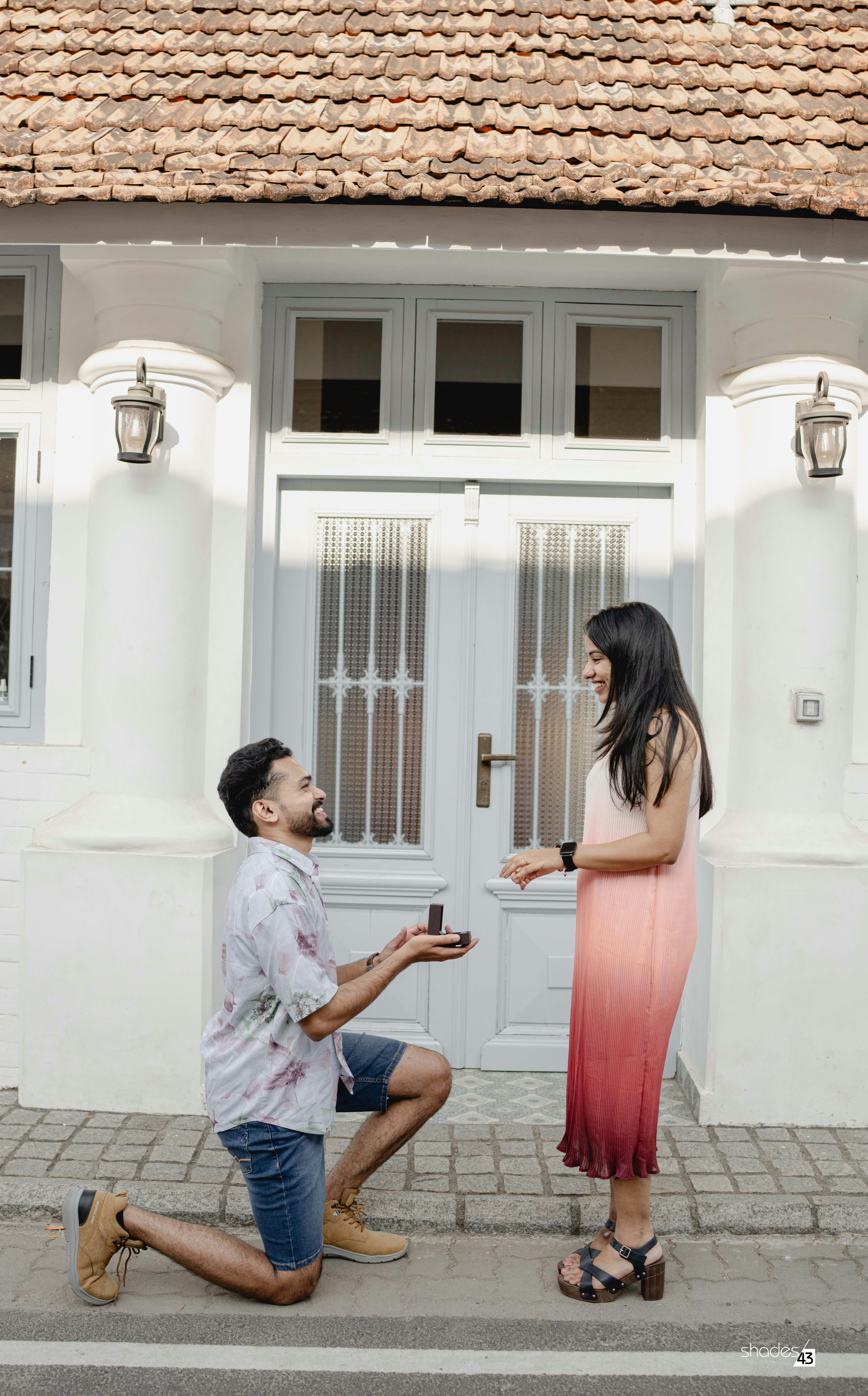 A man kneeling down next to a woman