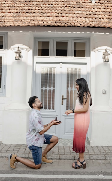 A man kneeling down next to a woman