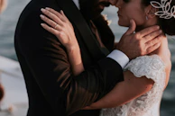 A bride and groom embracing on a boat