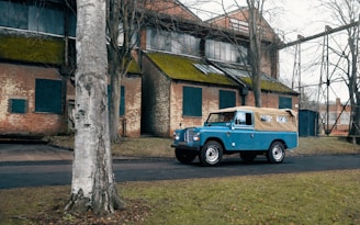 A blue truck parked in front of a building