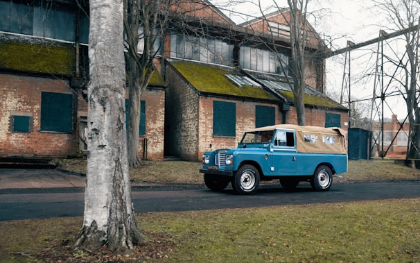 A blue truck parked in front of a building