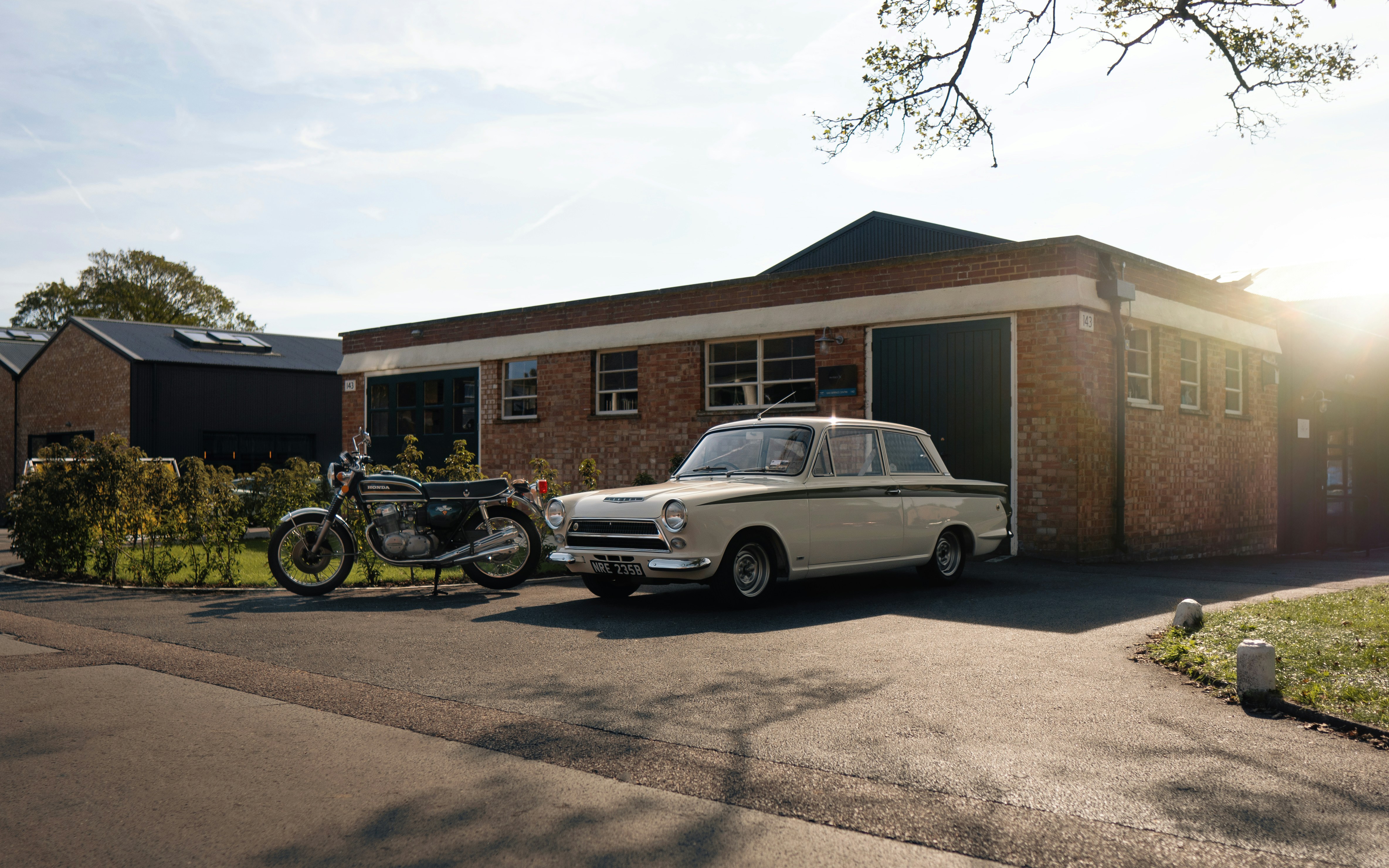 A white car parked in front of a brick building photo – Free Bicester ...