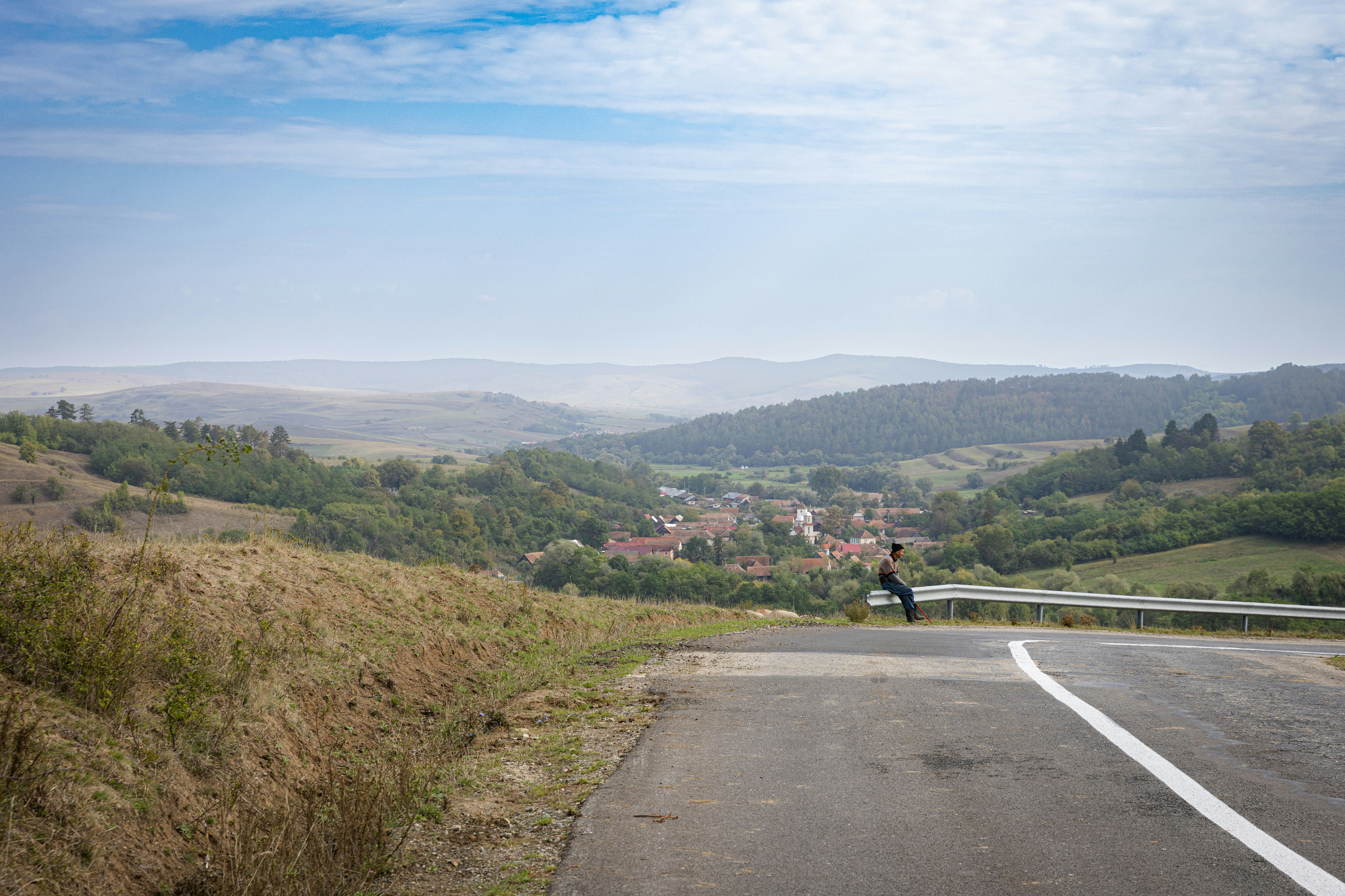 A person riding a motorcycle down a road